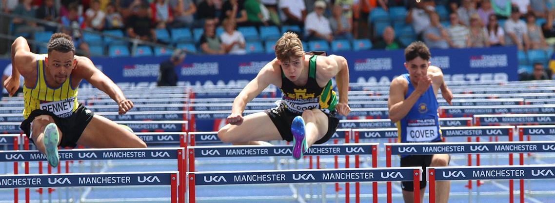 Tom Wilcock competing in the hurdles.