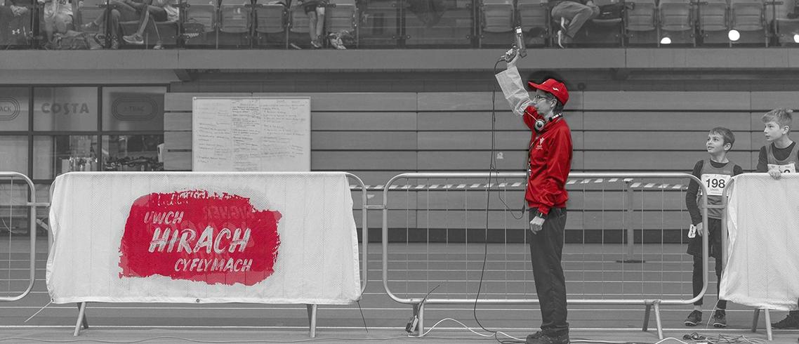 Sue Hooper an Official starting a race indoors